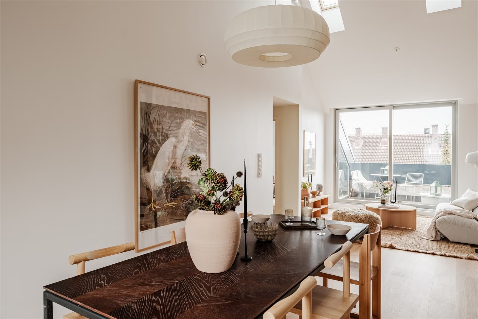 Open-plan dining and living area in the Living Under the Sky attic apartment in Oslo by IK-architects