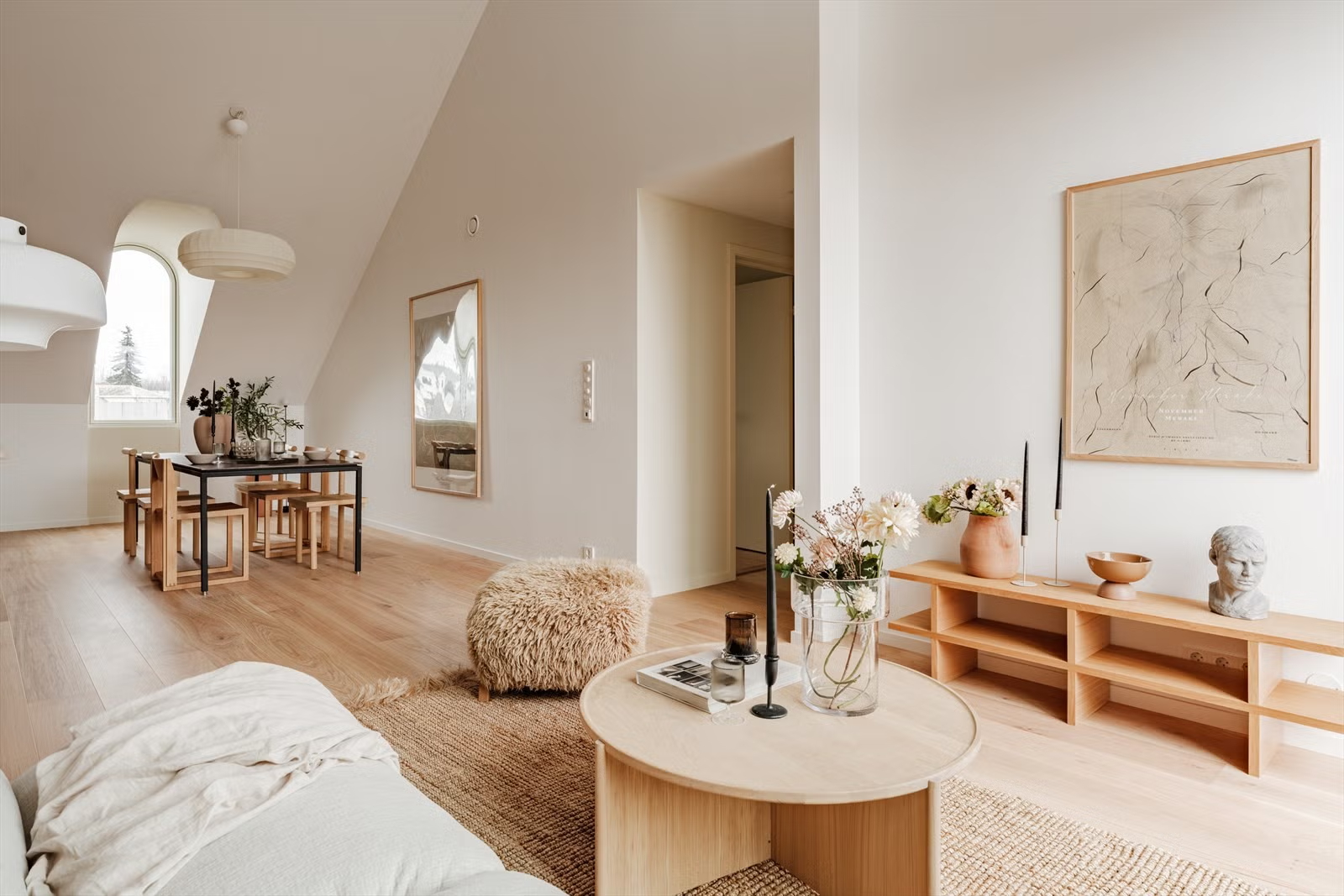 Open-plan living and dining area in the Living Under the Sky attic apartment in Oslo by IK-architects